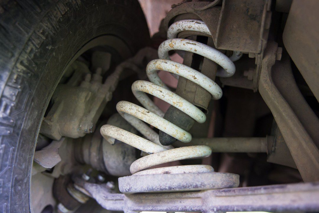 Fatigued, broken coil spring on an automobile.