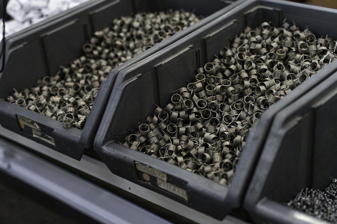 Containers holding materials for custom springs