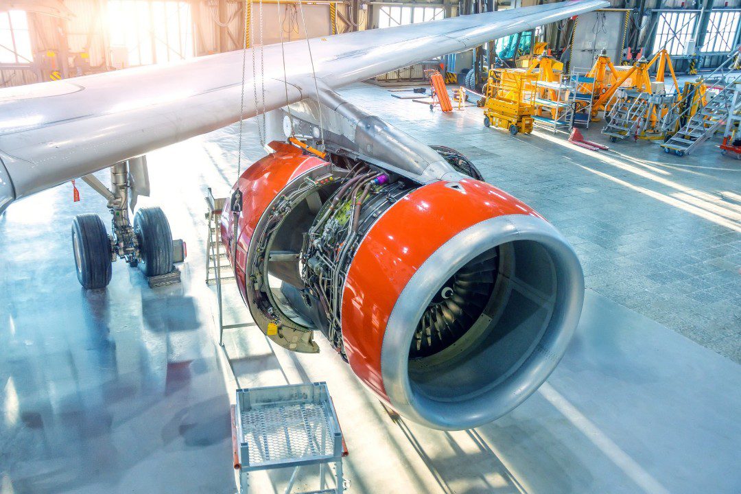 Plane being inspected inside a hangar for safety