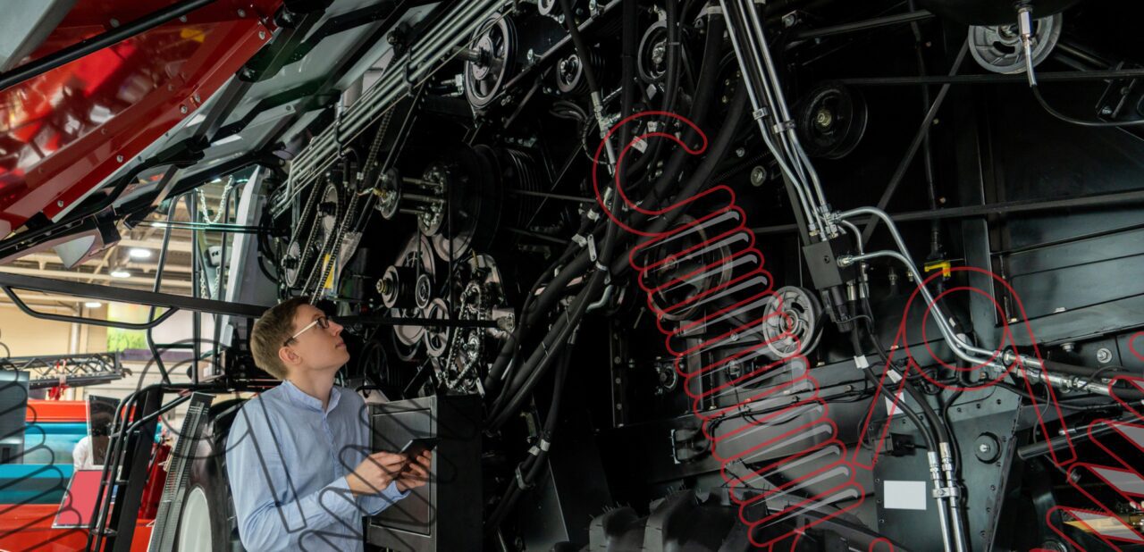 Technician inspecting farm machinery springs and wire forms